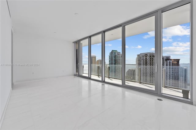 unfurnished room featuring floor to ceiling windows