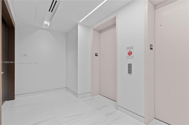 300 Biscayne Blvd Way Unit 2503, Miami, FL 33131 - corridor with elevator, light marble finish floors, and attic access