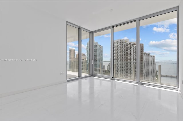 300 Biscayne Blvd Way Unit 2503, Miami, FL 33131 - unfurnished room featuring a wall of windows, a city view, and tile patterned floors