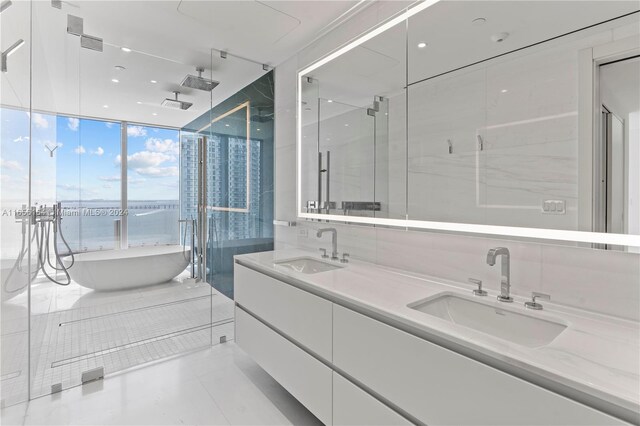 300 Biscayne Blvd Way Unit 2503, Miami, FL 33131 - full bath featuring a soaking tub, double vanity, a shower stall, a water view, and tile patterned floors