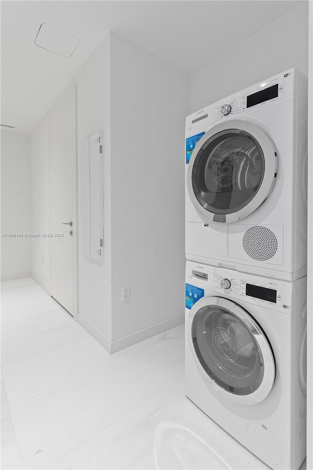 laundry area with stacked washer and clothes dryer