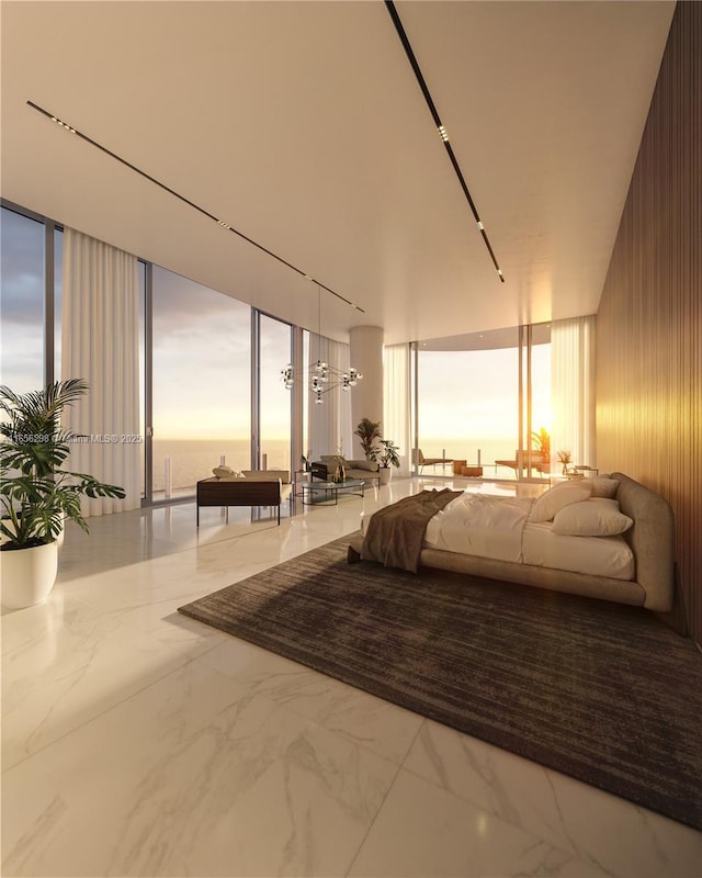 bedroom with expansive windows and a water view