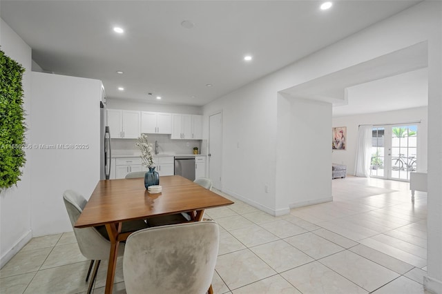 dining space featuring french doors and light tile patterned floors