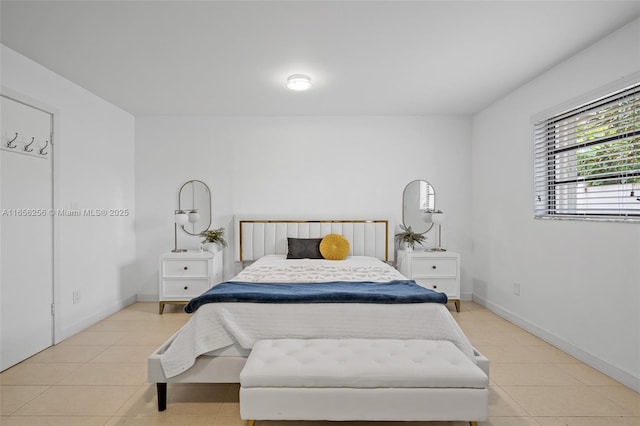 bedroom with light tile patterned floors