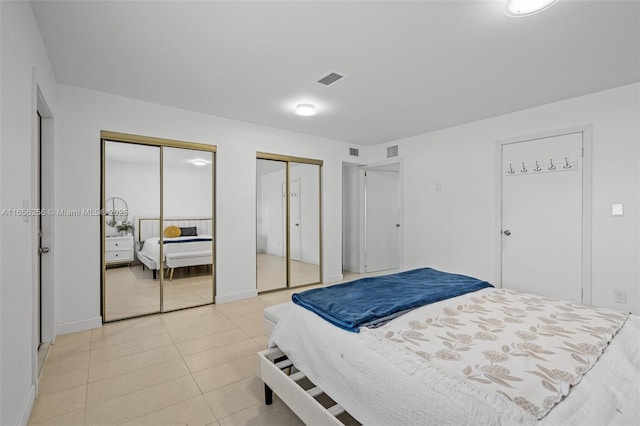 tiled bedroom with multiple closets