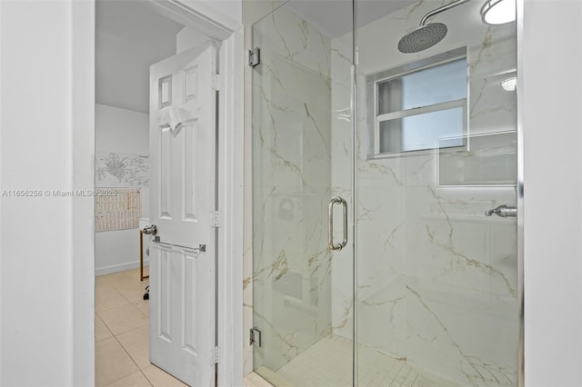 bathroom with a shower with shower door and tile patterned floors