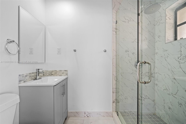 bathroom with toilet, decorative backsplash, a shower with door, tile patterned floors, and vanity