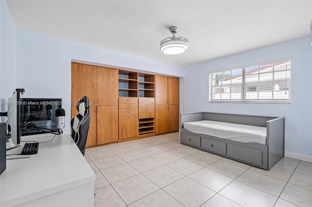 bedroom with a closet and light tile patterned floors