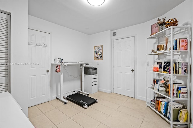 workout area with light tile patterned flooring