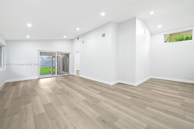 empty room featuring light hardwood / wood-style floors and lofted ceiling