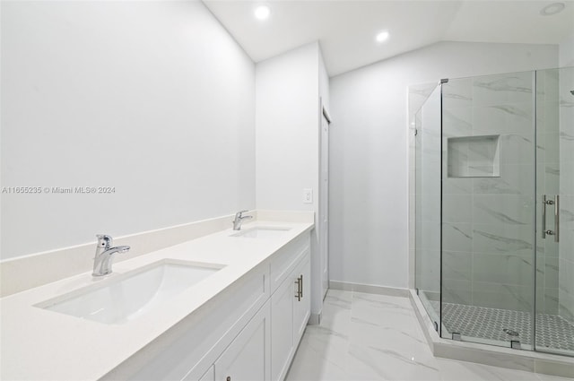 bathroom featuring vanity, a shower with shower door, and lofted ceiling