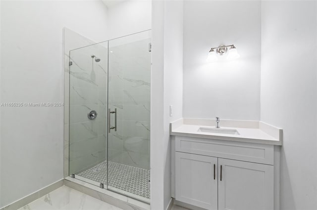 bathroom featuring vanity and a shower with door