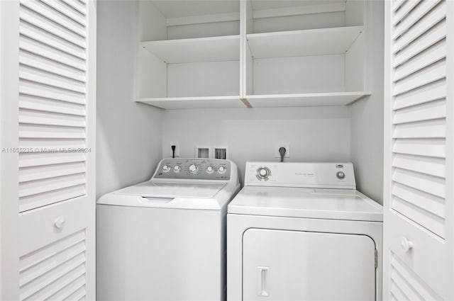 washroom with washing machine and clothes dryer