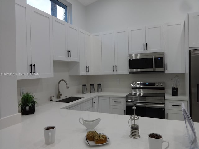 kitchen featuring sink, white cabinets, and stainless steel appliances