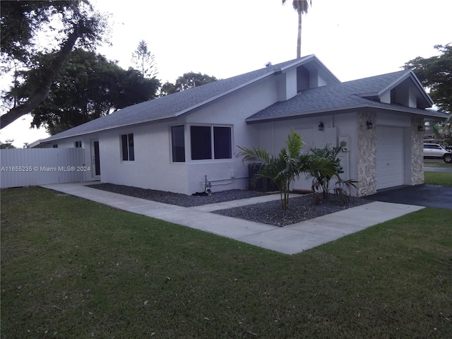 exterior space with a yard and a garage