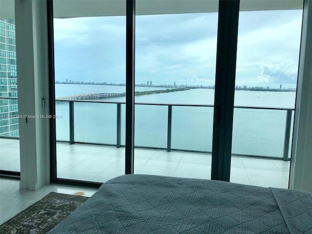 tiled bedroom with a water view