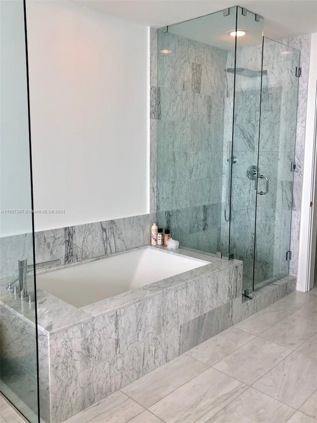 bathroom featuring shower with separate bathtub