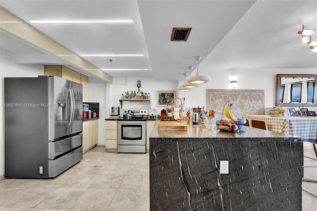 kitchen featuring cream cabinetry, stainless steel appliances, and sink