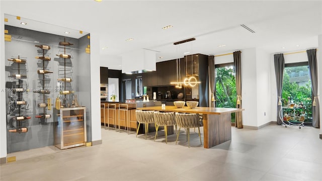 kitchen with beverage cooler, a breakfast bar area, and backsplash