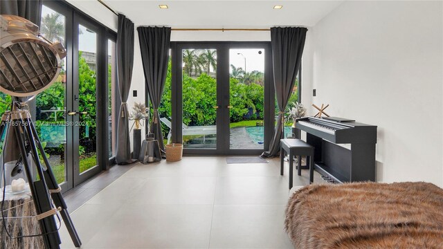 living area featuring floor to ceiling windows, plenty of natural light, and french doors