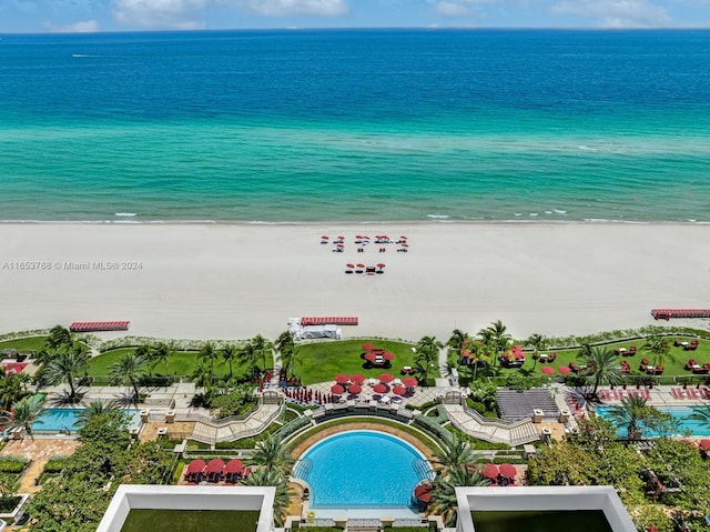 bird's eye view with a water view and a beach view