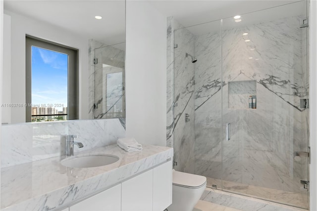 bathroom featuring vanity, toilet, and a shower with door