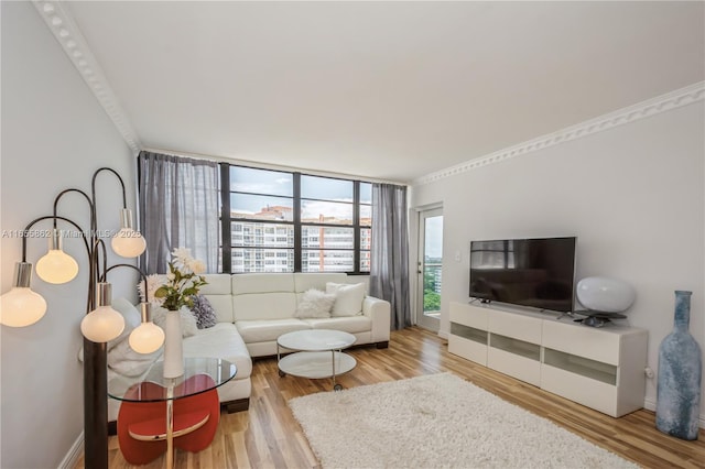 living room featuring wood-type flooring, a wall of windows, and crown molding