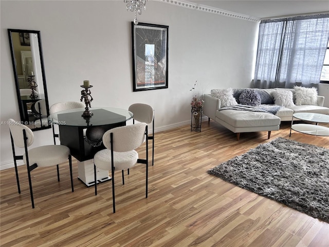 living room featuring wood-type flooring, an inviting chandelier, and floor to ceiling windows