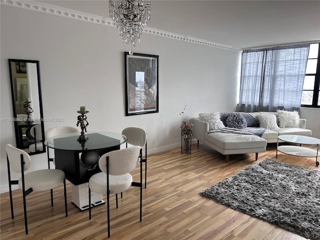 dining space with wood-type flooring, an inviting chandelier, and floor to ceiling windows