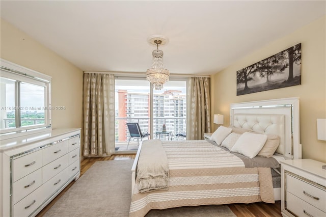 bedroom with hardwood / wood-style flooring and a notable chandelier