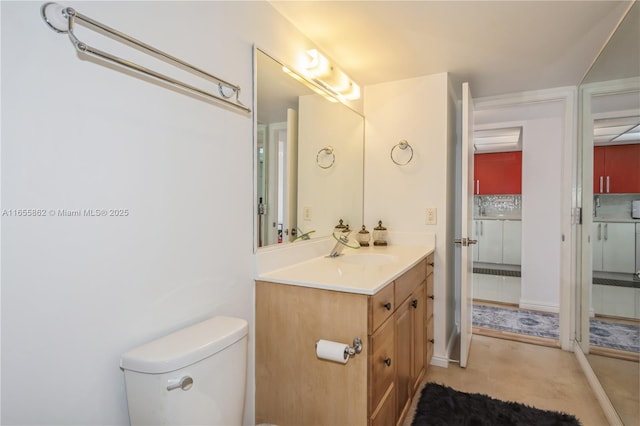 bathroom with toilet and vanity