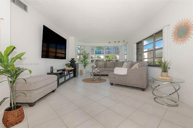 tiled living room featuring a textured ceiling