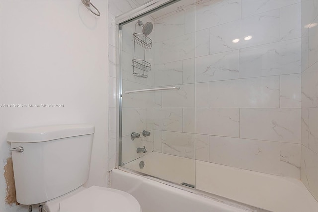 bathroom featuring shower / bath combination with glass door and toilet