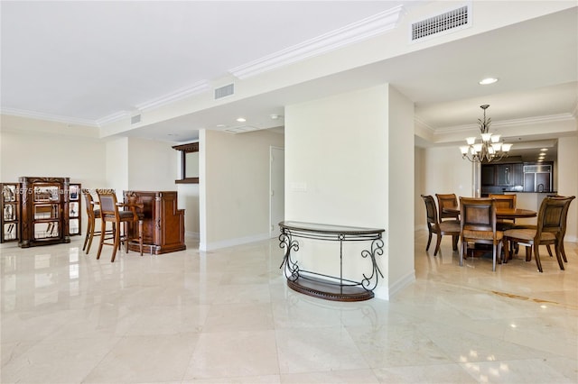 interior space featuring crown molding and an inviting chandelier