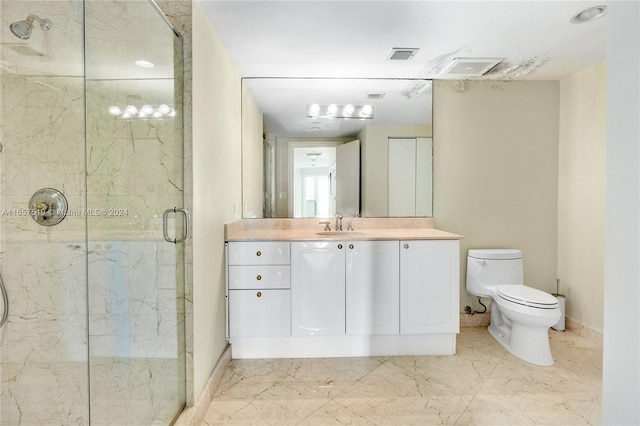 bathroom featuring an enclosed shower, vanity, and toilet