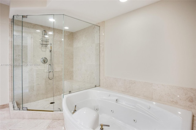 bathroom featuring shower with separate bathtub