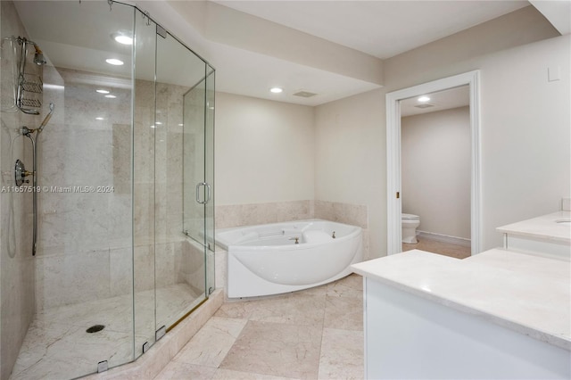 full bathroom featuring independent shower and bath, vanity, and toilet