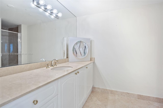 bathroom with vanity, a shower with door, and tile patterned floors