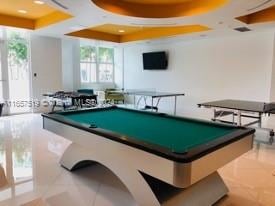 rec room featuring pool table and a tray ceiling