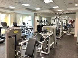 gym with a paneled ceiling