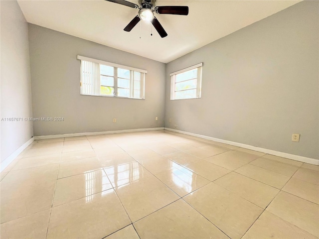 empty room featuring ceiling fan and light tile patterned floors