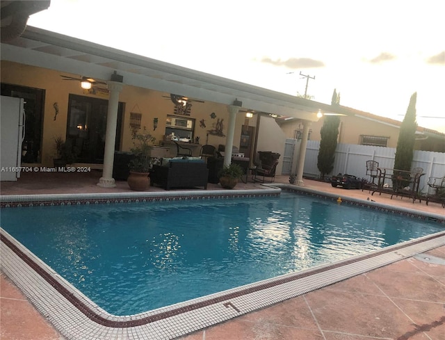 view of swimming pool featuring a patio and ceiling fan