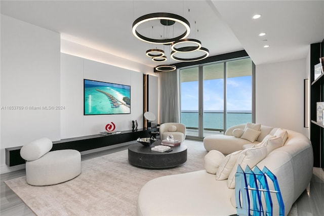 living room featuring a water view, hardwood / wood-style flooring, and expansive windows