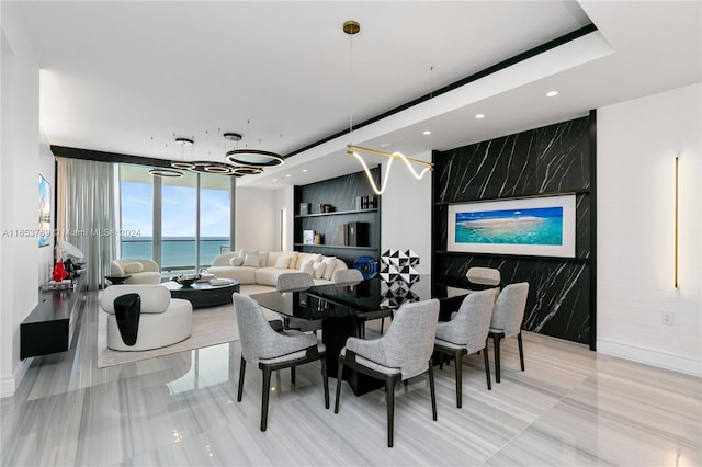 dining room with a water view and expansive windows