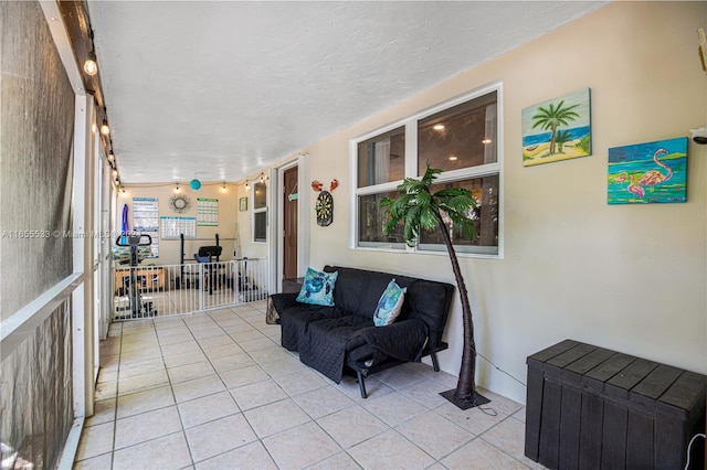 living room with a textured ceiling and light tile patterned floors