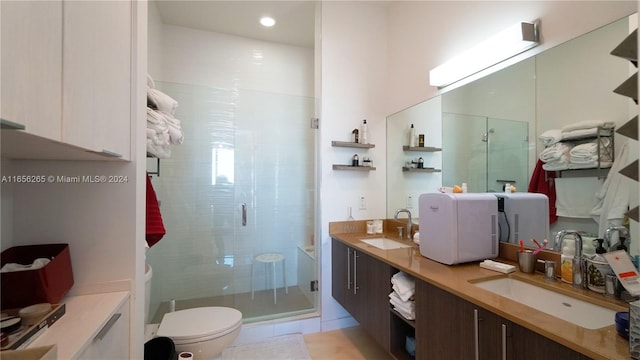 bathroom featuring walk in shower, vanity, toilet, and tile patterned floors