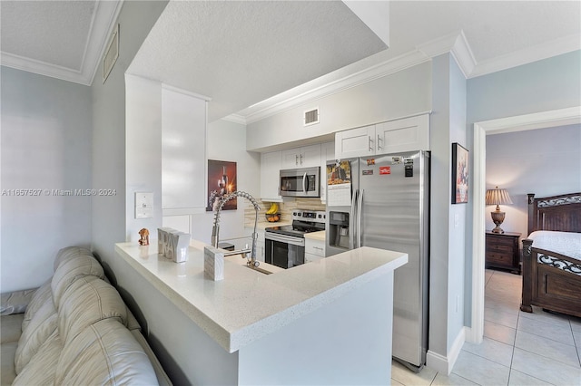 kitchen with kitchen peninsula, white cabinetry, stainless steel appliances, and ornamental molding