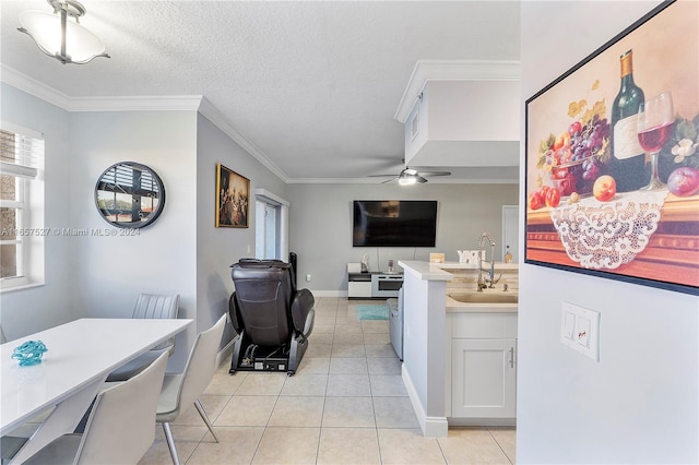 kitchen featuring a textured ceiling, ceiling fan, crown molding, light tile patterned floors, and white cabinetry