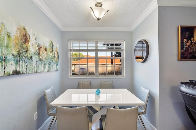 dining room with crown molding and a textured ceiling