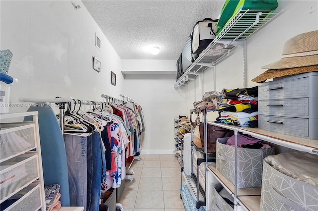 spacious closet with light tile patterned floors